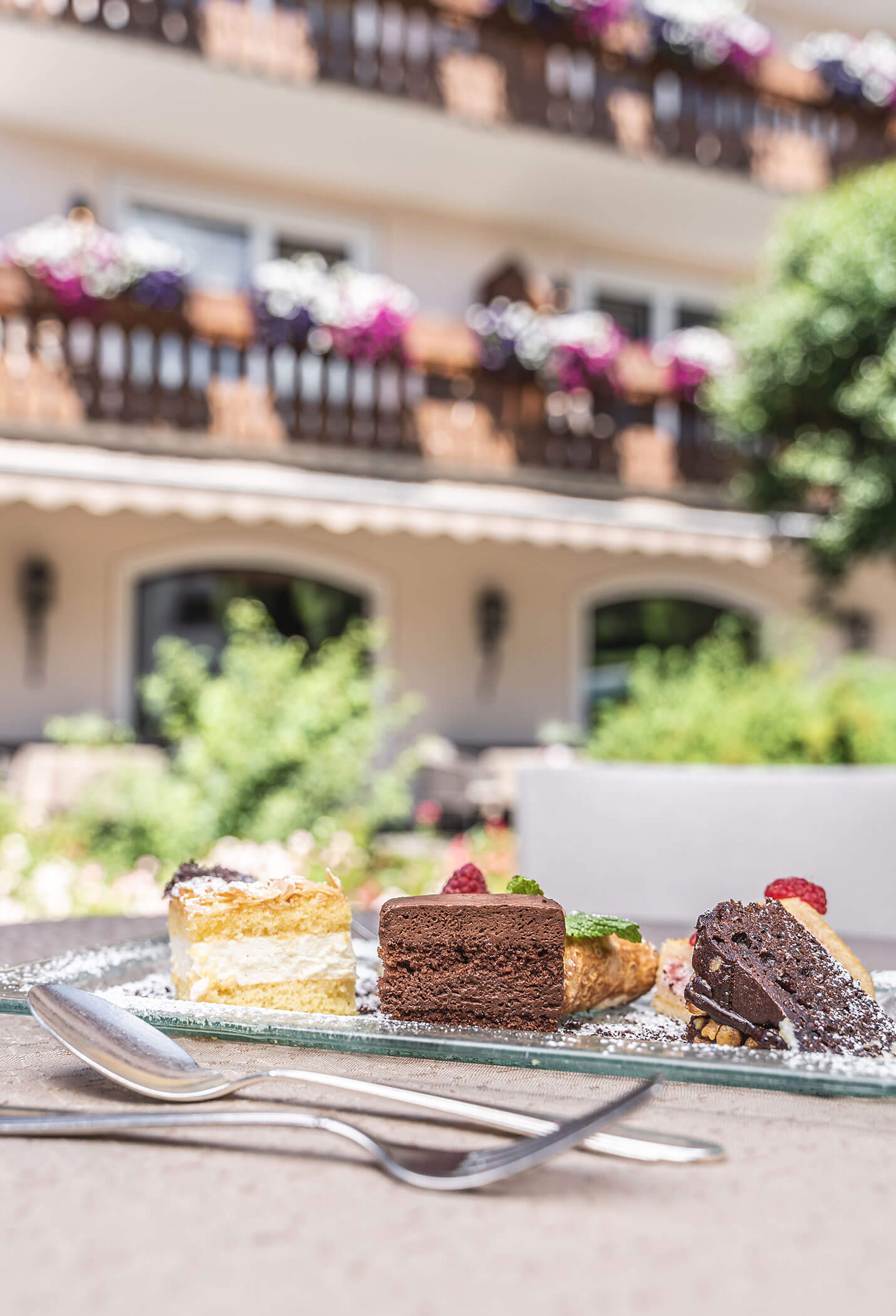 Various pieces of cake on a plate, cutlery in front - Vitalhotel Erica